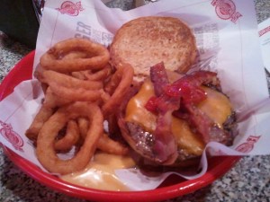 Fuddruckers Bacon Cheddar Cheeseburger with onion rings